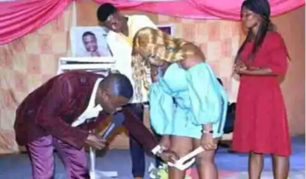 Viral Photo Of A ‘Prophet’ Removing A Lady’s Underwear In Church